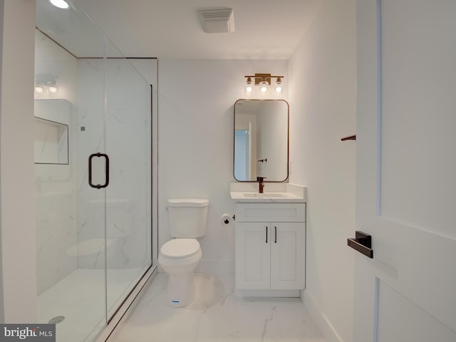 bathroom featuring tile patterned flooring, vanity, toilet, and a shower with shower door