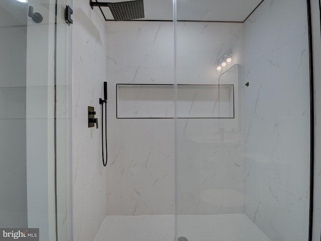 bathroom featuring a shower with shower door