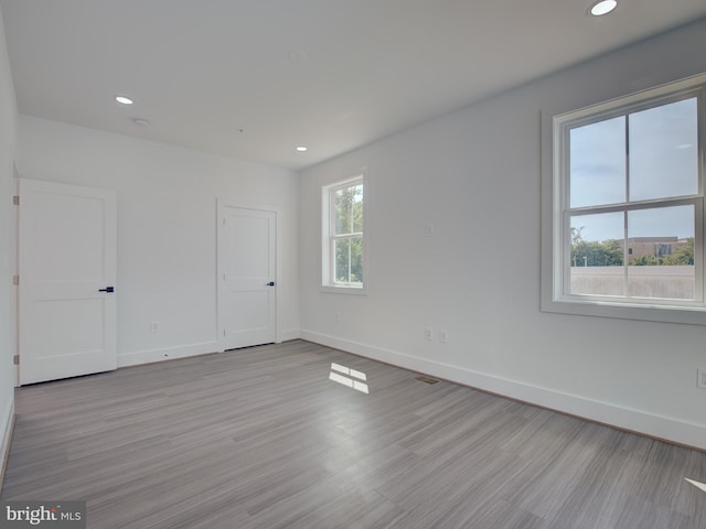 unfurnished room with light hardwood / wood-style floors