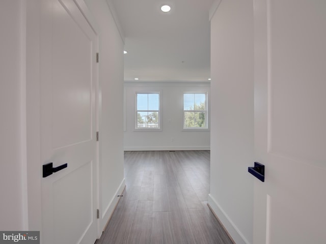 corridor with hardwood / wood-style flooring