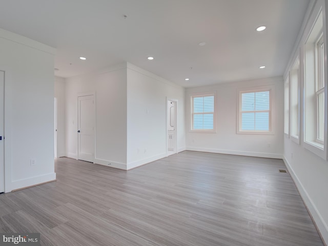 spare room with light hardwood / wood-style flooring