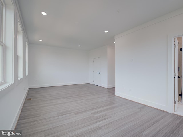 spare room featuring light wood-type flooring