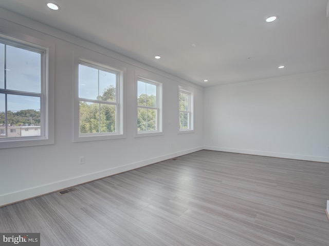 spare room with light hardwood / wood-style flooring