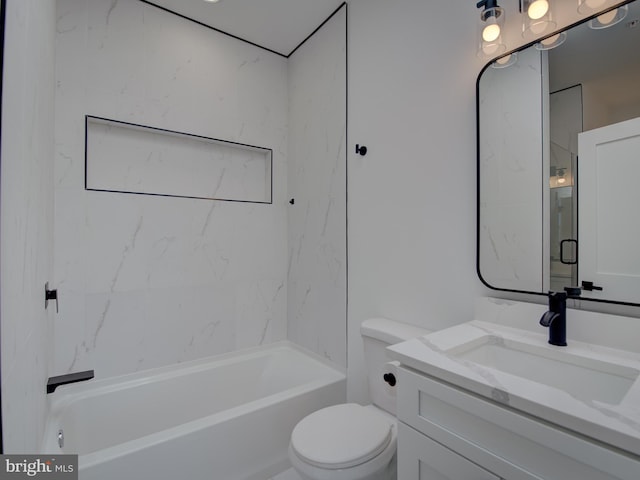 full bathroom featuring tiled shower / bath, vanity, and toilet