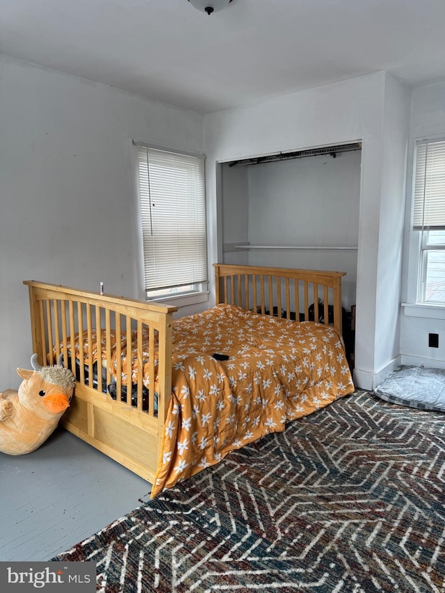 bedroom with brick floor and baseboards