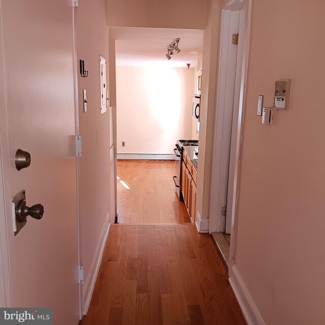 corridor featuring hardwood / wood-style floors and electric panel