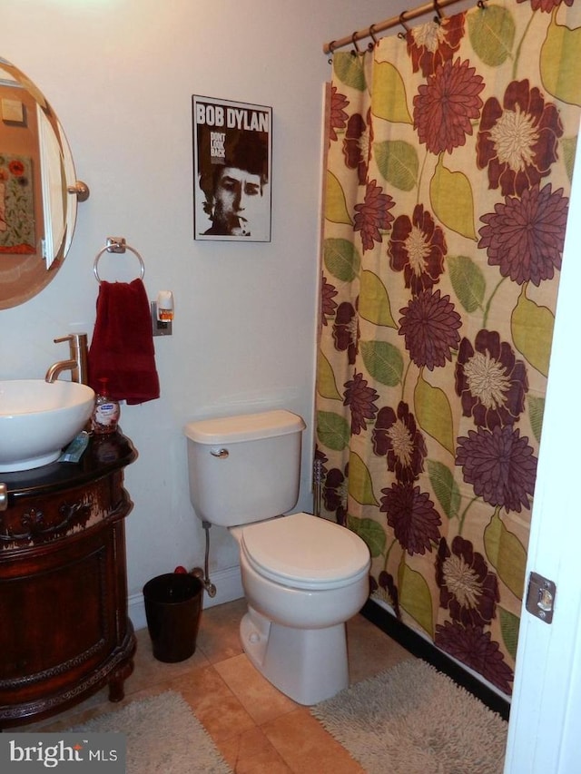 bathroom featuring vanity, a shower with shower curtain, toilet, and tile patterned flooring