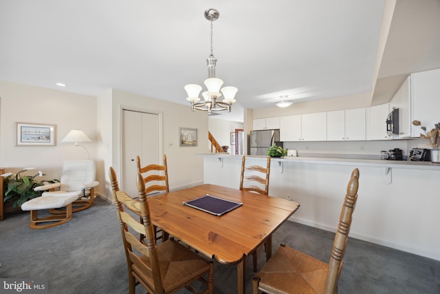 carpeted dining area featuring a chandelier