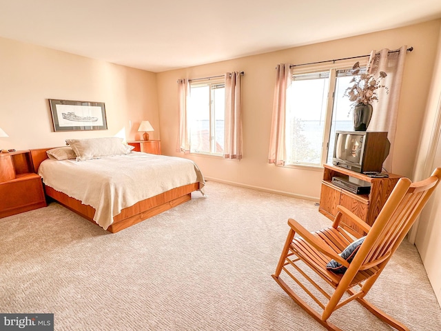 carpeted bedroom featuring baseboards