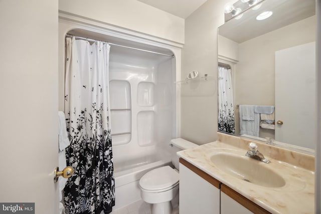 bathroom with vanity, shower / bath combination with curtain, and toilet