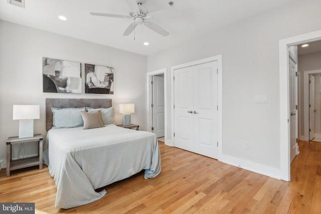 bedroom featuring light wood-type flooring, a closet, and ceiling fan