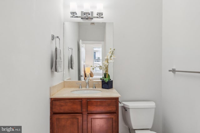 bathroom with vanity and toilet