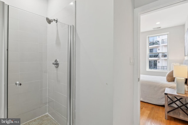 bathroom featuring walk in shower and wood-type flooring