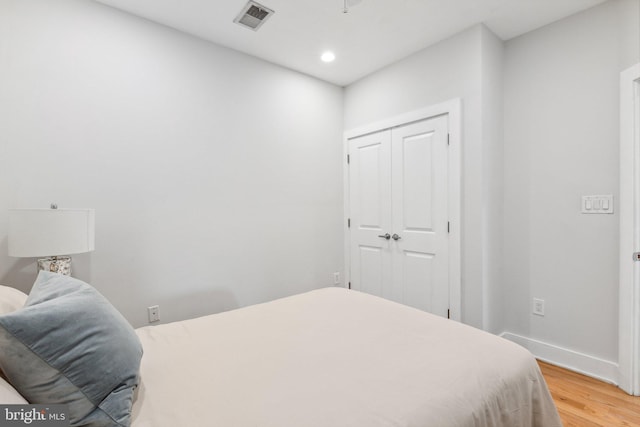 bedroom with a closet and light hardwood / wood-style floors