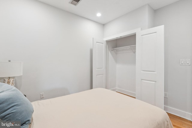 bedroom featuring light wood-type flooring and a closet