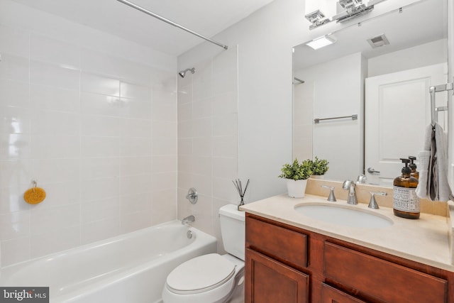 full bathroom featuring vanity, toilet, and tiled shower / bath combo