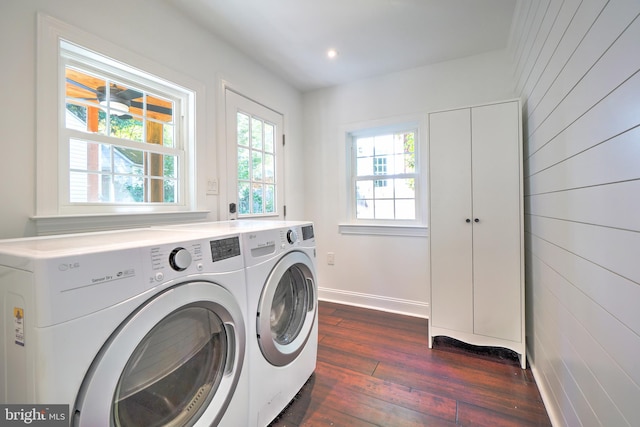 washroom with dark wood-type flooring and separate washer and dryer