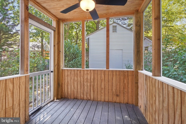 unfurnished sunroom featuring ceiling fan and wooden ceiling