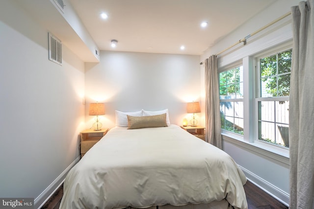 bedroom with dark wood-type flooring