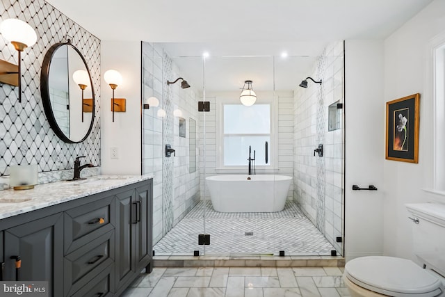 full bathroom featuring vanity, toilet, and independent shower and bath