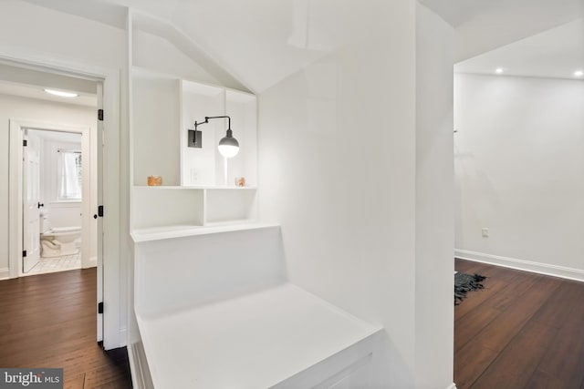 bathroom with toilet, wood-type flooring, and vaulted ceiling