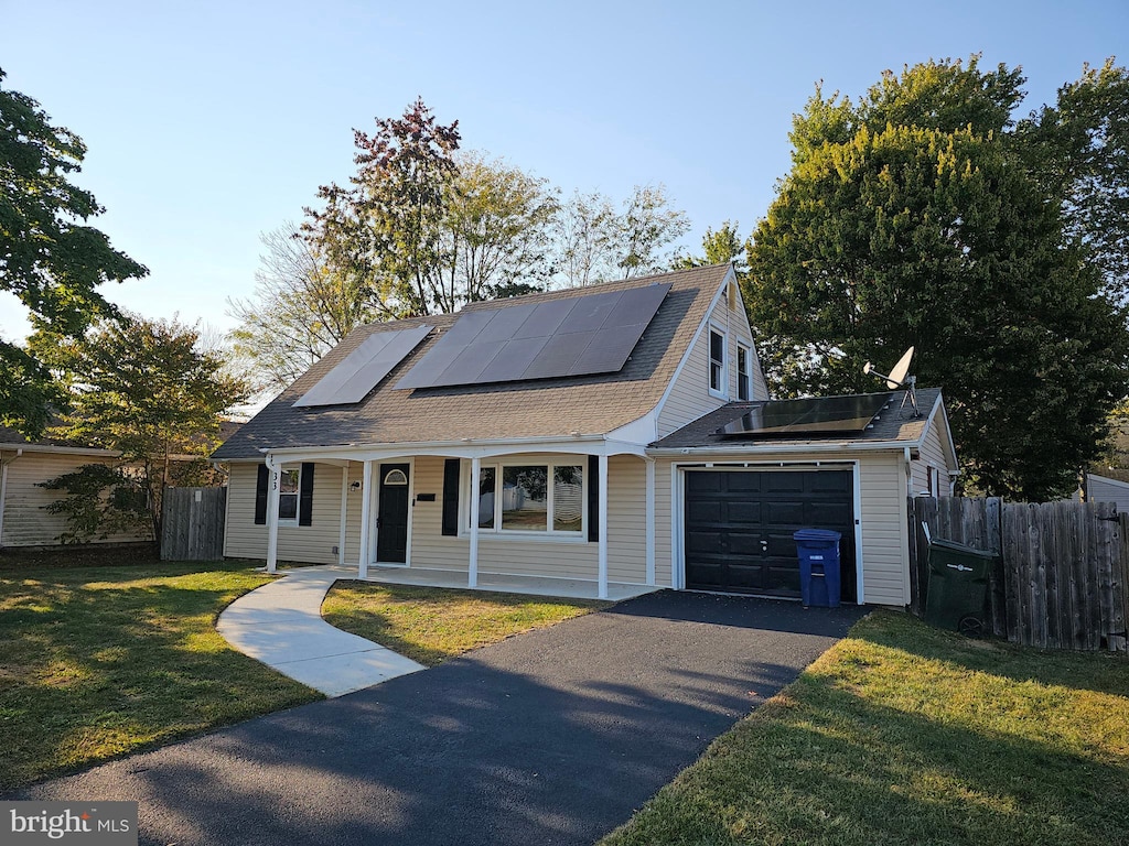 view of front of house with solar panels and a front lawn