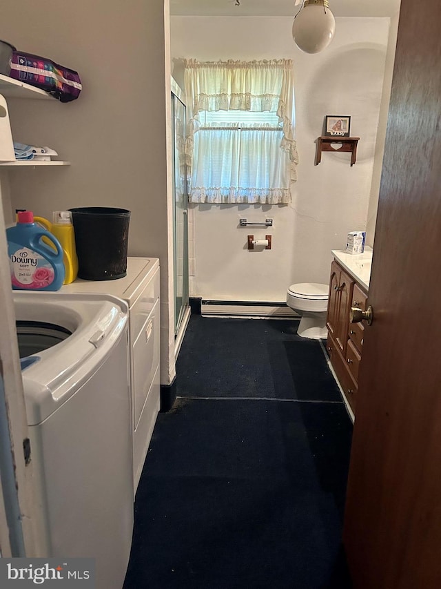 laundry area with laundry area, washer and clothes dryer, and baseboard heating