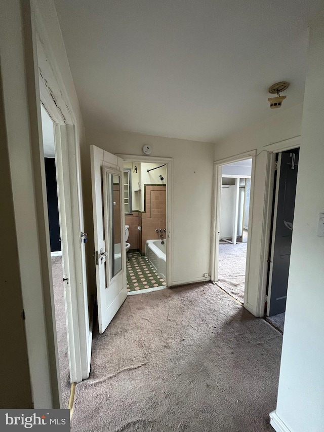 hallway with carpet flooring and french doors