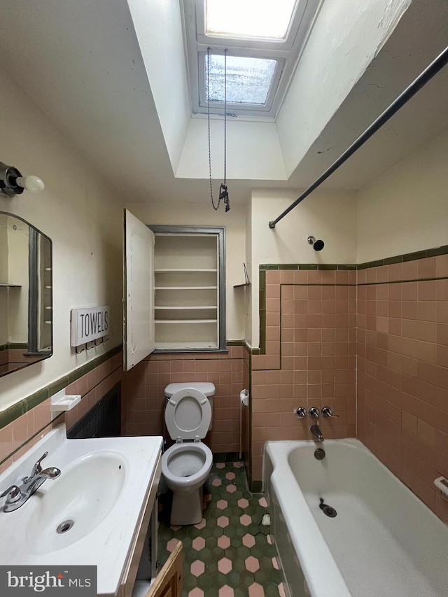 full bathroom featuring shower / tub combination, vanity, tile walls, and toilet