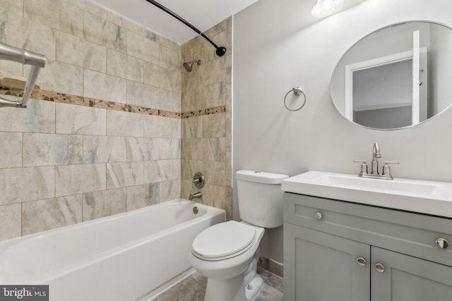 full bathroom with toilet, tiled shower / bath, vanity, and tile patterned floors