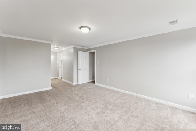 carpeted empty room featuring crown molding