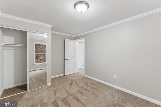 unfurnished bedroom featuring a closet, crown molding, and light carpet