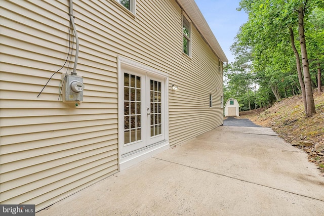 view of property exterior with a patio area and french doors