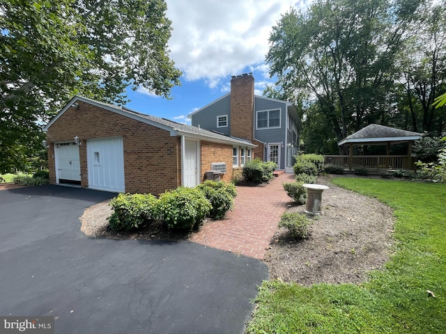 view of side of home featuring a yard and a garage