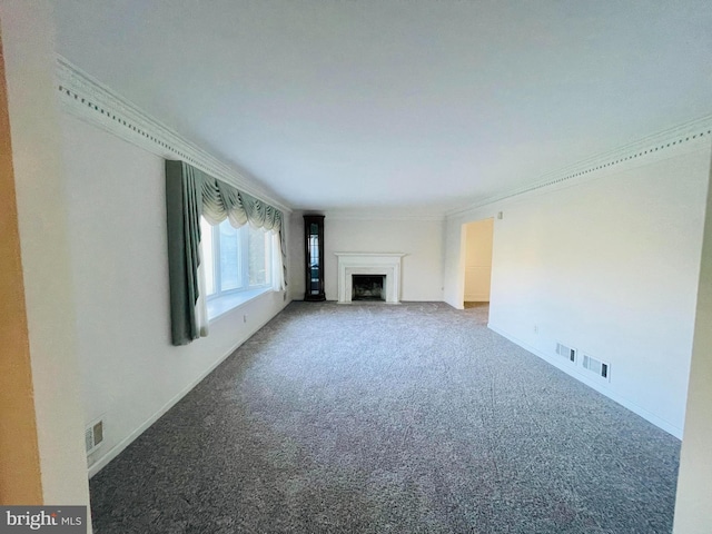 unfurnished living room with ornamental molding and carpet floors