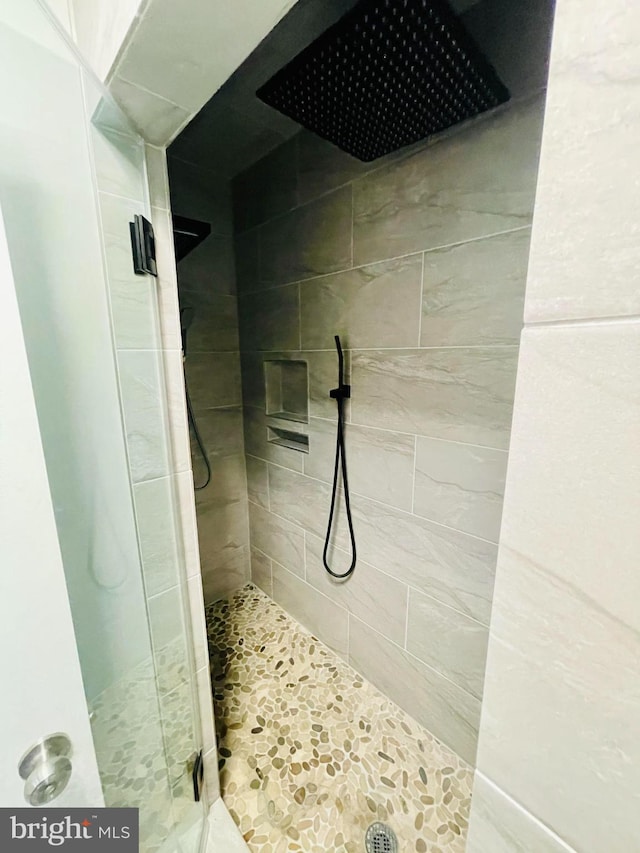 bathroom with a shower with shower door