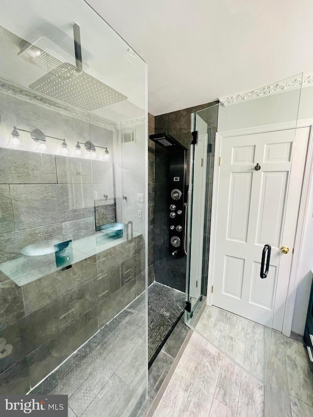 bathroom featuring a shower with door