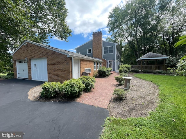 view of side of property with a yard and a garage