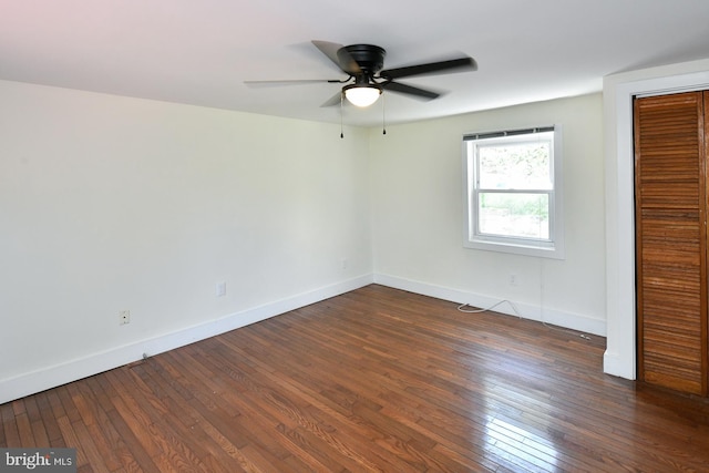 unfurnished bedroom featuring dark wood-type flooring, ceiling fan, and a closet