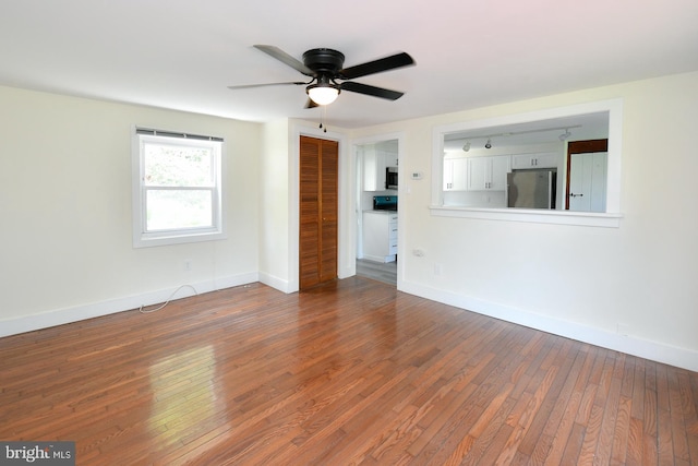 unfurnished living room with hardwood / wood-style floors and ceiling fan