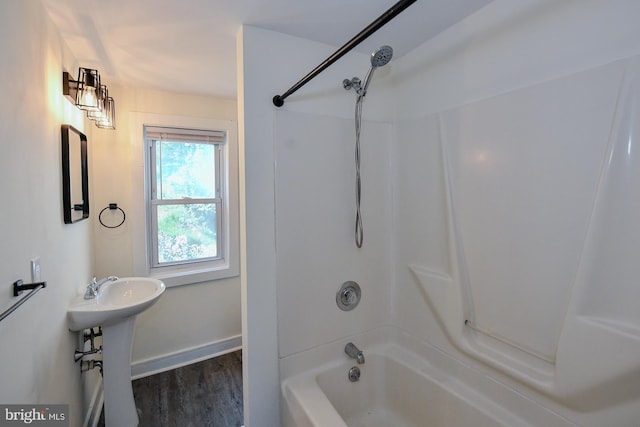 bathroom with shower / bathing tub combination and hardwood / wood-style flooring