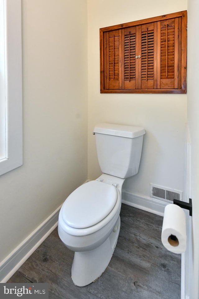 bathroom featuring toilet and wood-type flooring