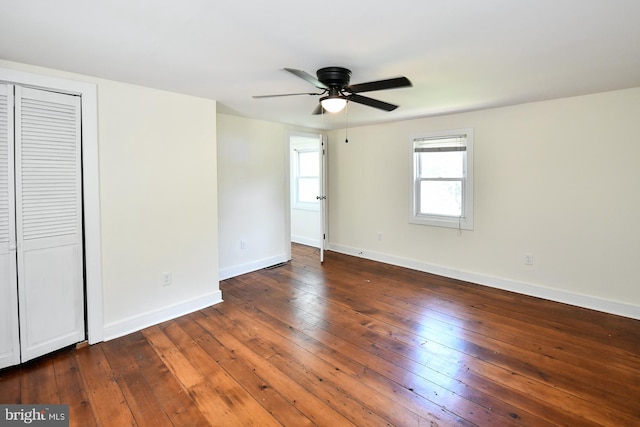 unfurnished bedroom featuring ceiling fan and dark hardwood / wood-style floors