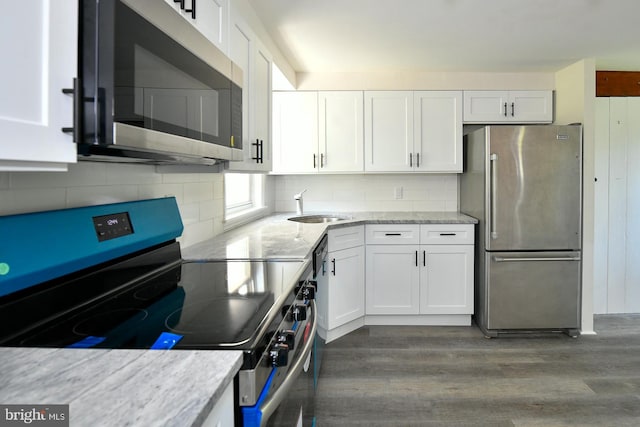 kitchen with white cabinetry, wood-type flooring, and stainless steel appliances