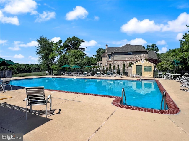 view of swimming pool featuring a patio area