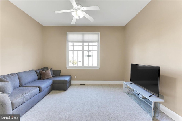 carpeted living room with ceiling fan