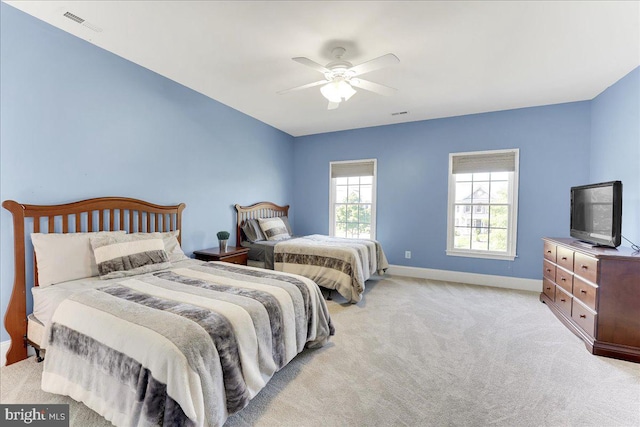 bedroom with ceiling fan and light colored carpet