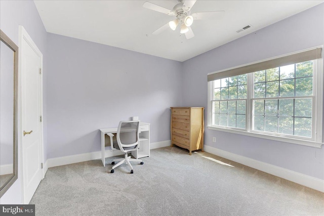 home office featuring light carpet and ceiling fan