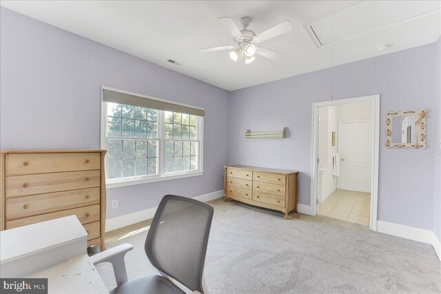 home office featuring light carpet and ceiling fan