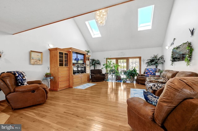 living room featuring a skylight, high vaulted ceiling, and light wood-style floors